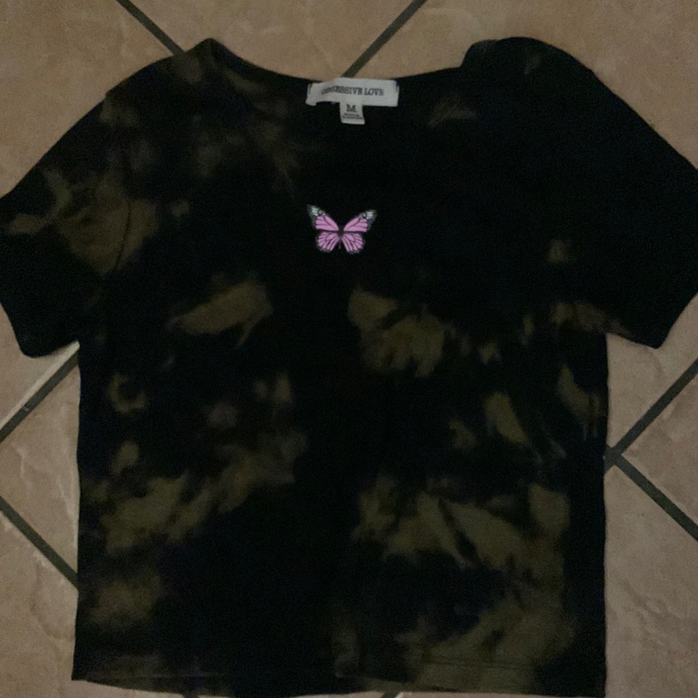 The brand is Obsessive Love,black shirt,has bleach spots,has a pink butterfly